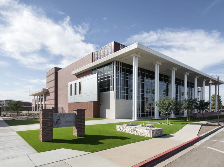 School building with tall white columns and a lawn